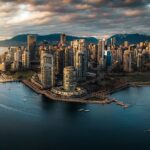 Aerial view of downtown Vancouver at sunset, looking across False Creek to the harbour and the North Shore mountains